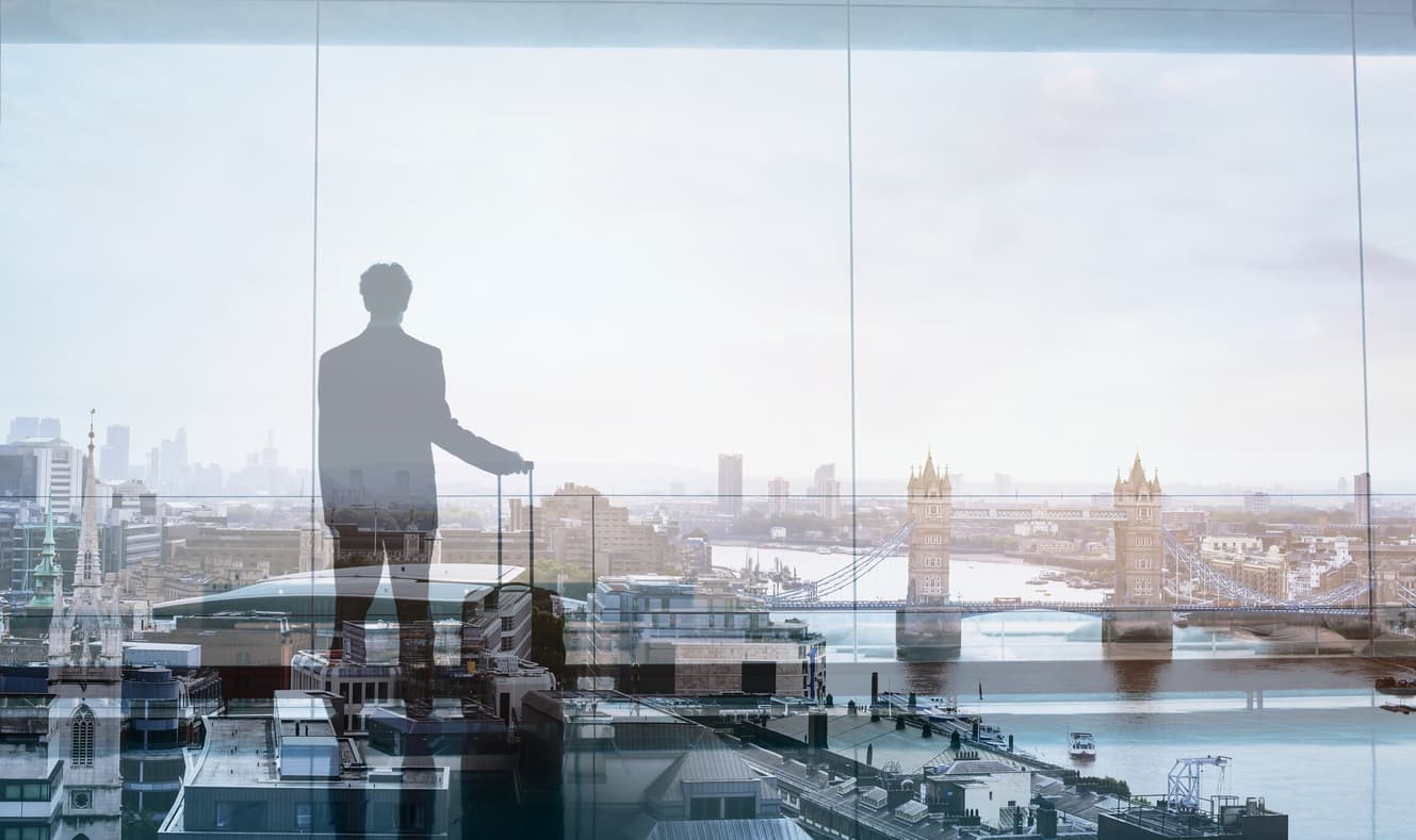 A silhouette of a man with luggage at a European airport, symbolizing the trend of wealthy americans leaving the US.