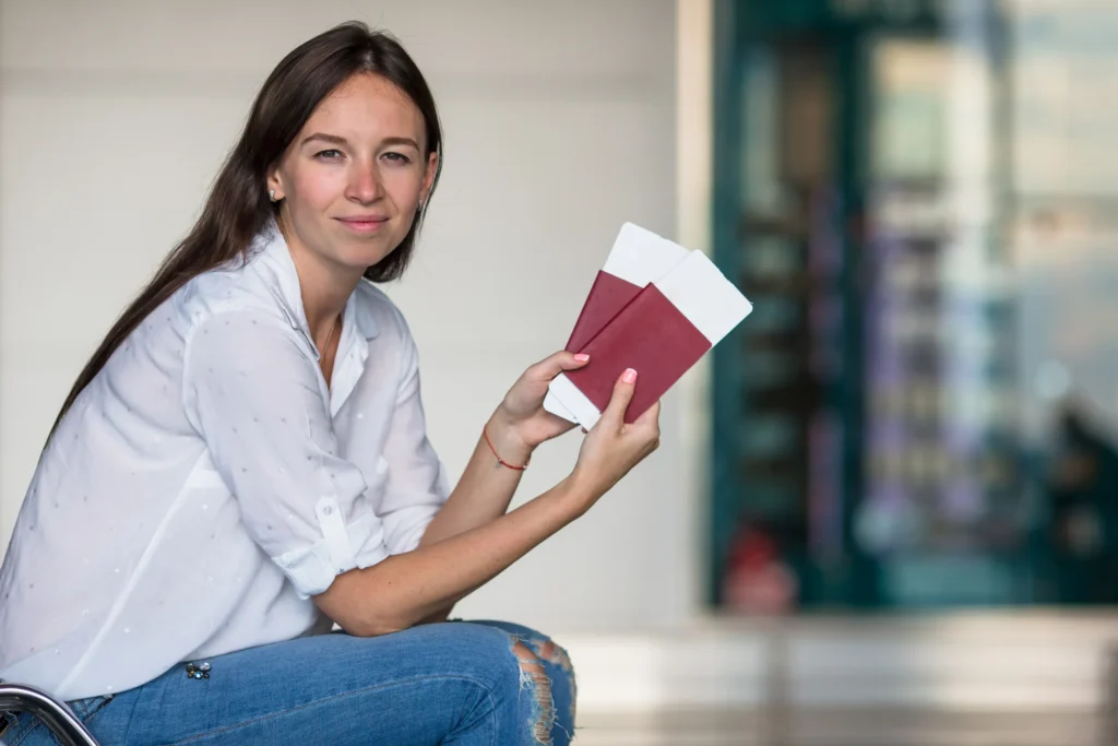 How Trump’s Global Impact Is Shaping Migration Patterns 7 happy young woman with air ticket and passports at 2025 02 12 00 17 34 utc