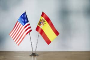 American Emigration Revue 8 American and Spanish flag, depicting the large influx of Americans moving to Spain