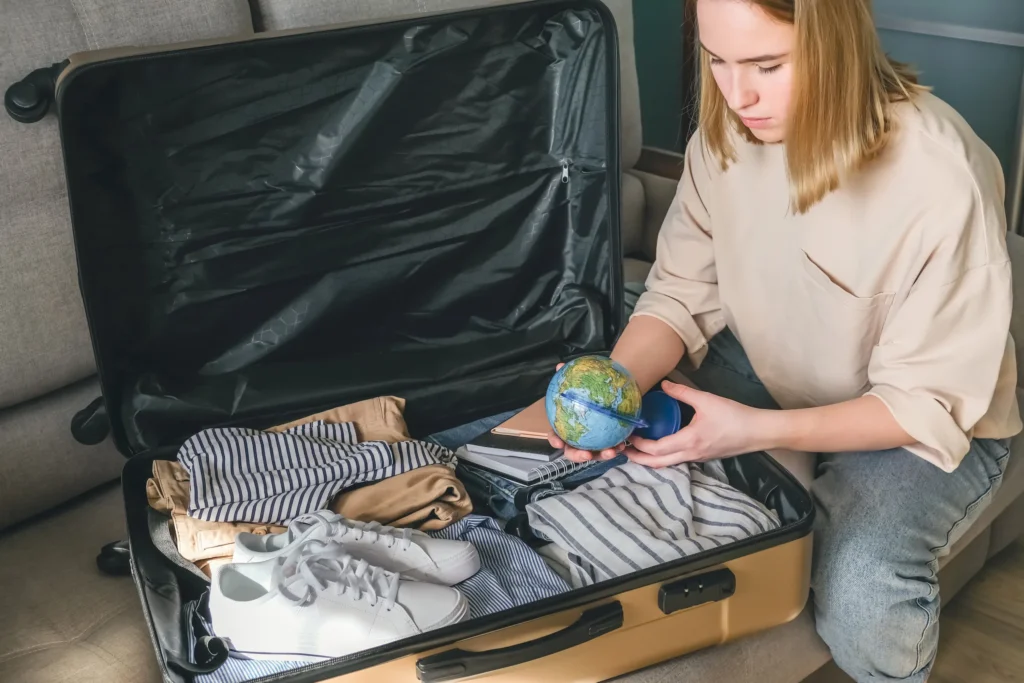 travel girl collects a suitcase for travel online 2025 03 11 06 45 12 utc