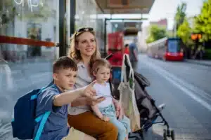 young-mother-with-little-kids-waiting-on-bus-stop