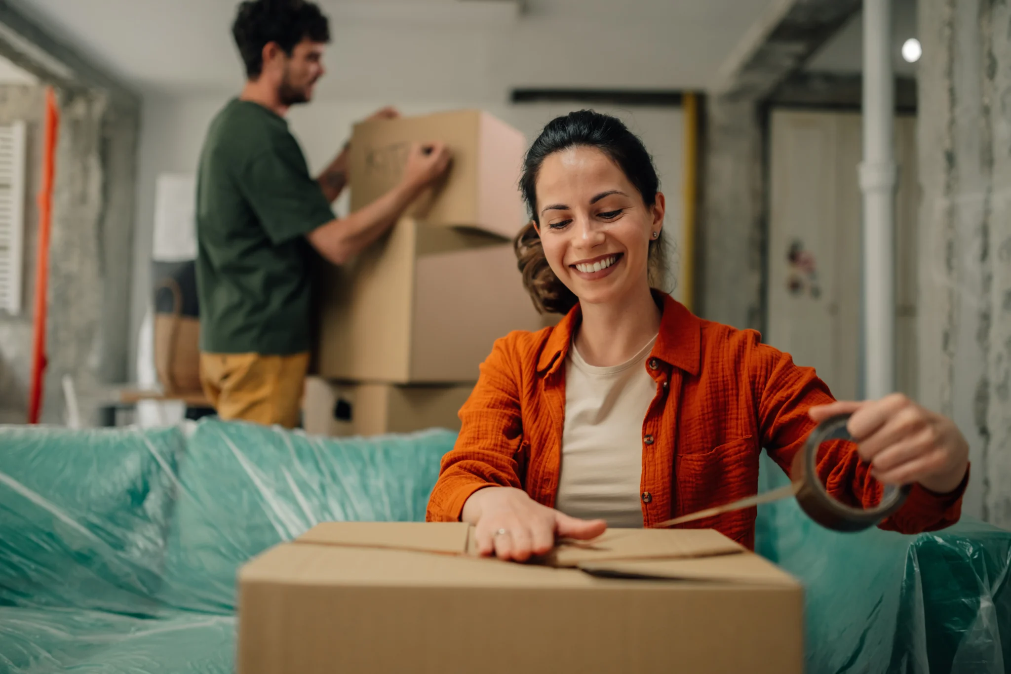 couple-packing-boxes-and-protecting-furniture-gett
