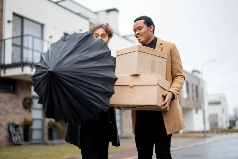 gay-couple-walking-together-with-parcels-outdoors