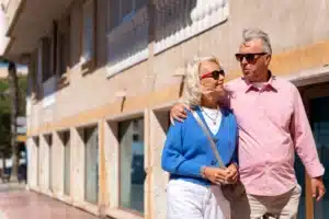 senior-couple-enjoying-sunny-stroll-on-vacation