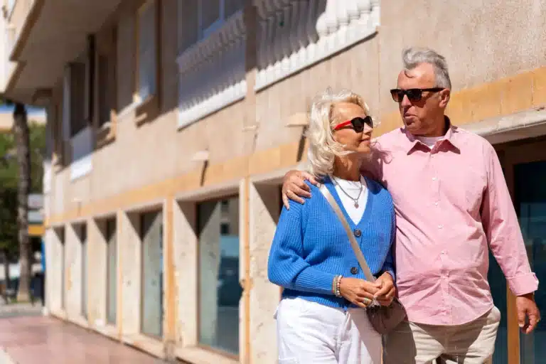 senior-couple-enjoying-sunny-stroll-on-vacation
