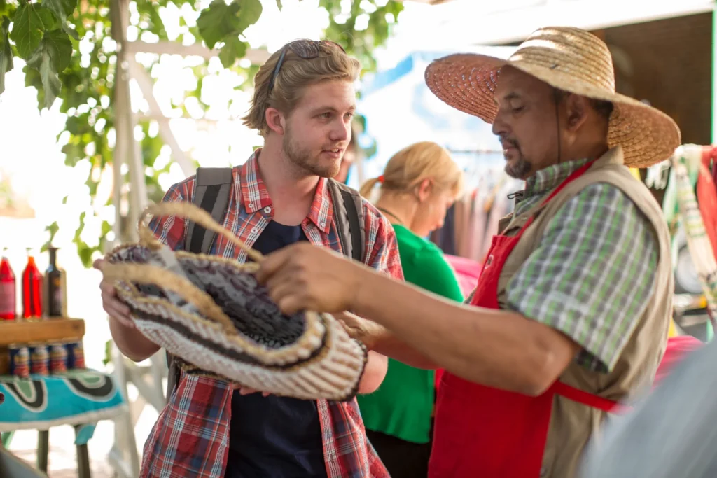 Why Mexico City Is Attracting More Americans Than Ever 4 market trader selling bag to tourist 2025 04 04 19 24 09 utc