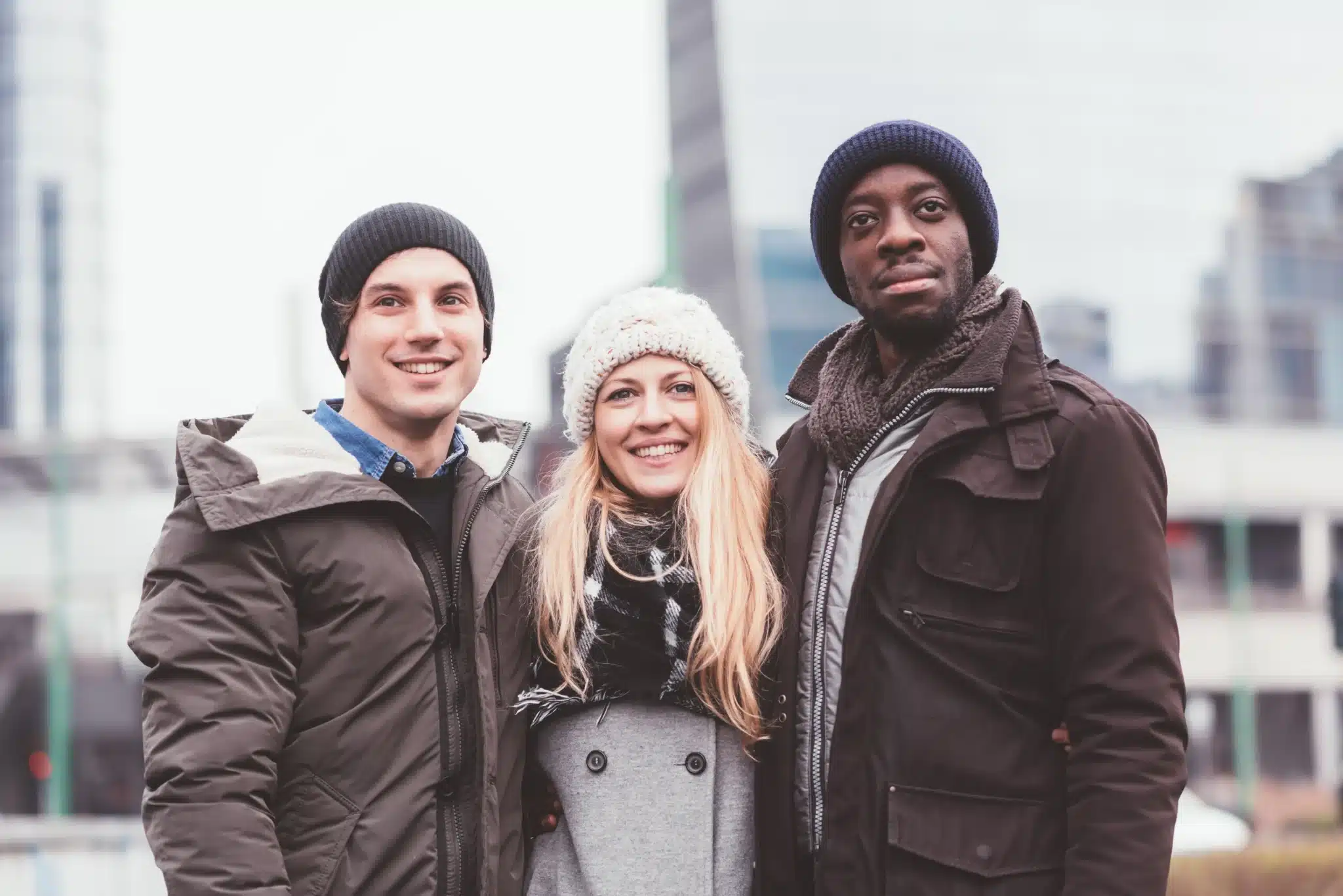three-young-friends-posing-together-in-the-street