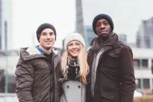 three-young-friends-posing-together-in-the-street