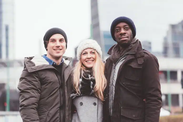 three-young-friends-posing-together-in-the-street