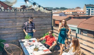 friends-talking-and-drinking-at-a-party-on-a-terrace