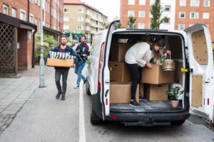 man-and-women-putting-furniture-into-rental-car