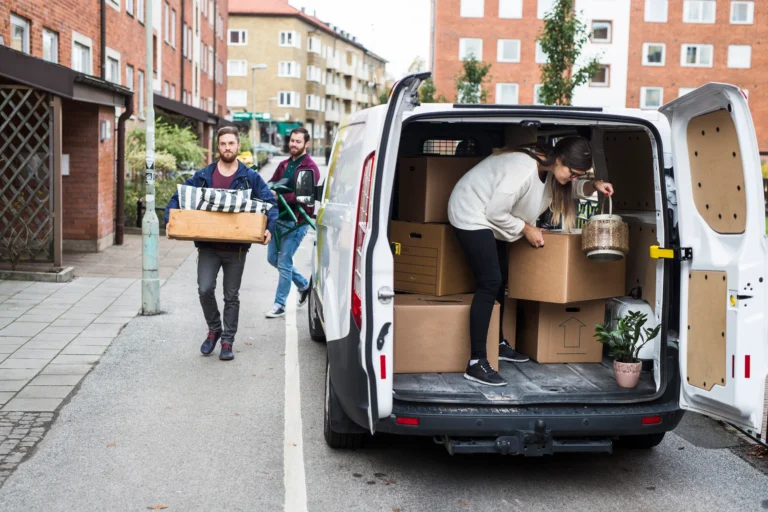 man-and-women-putting-furniture-into-rental-car