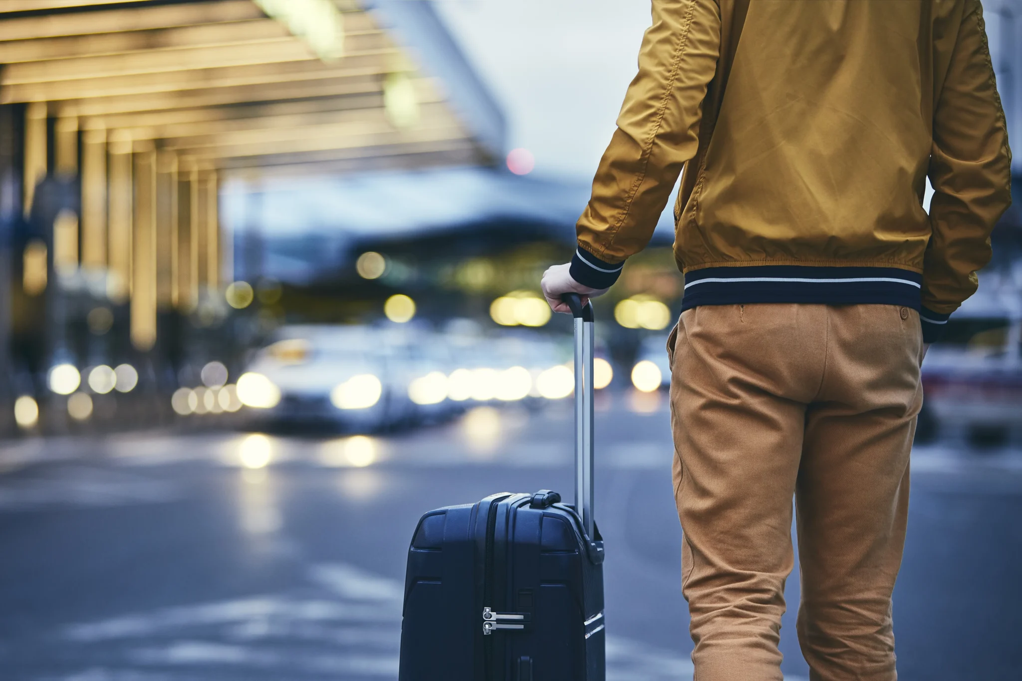 passenger-walking-outside-airport-terminal-rear
