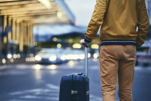 passenger-walking-outside-airport-terminal-rear