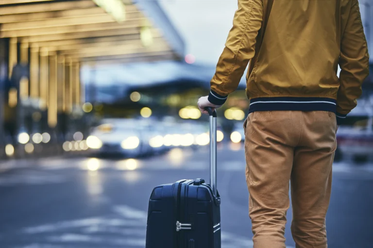 passenger-walking-outside-airport-terminal-rear