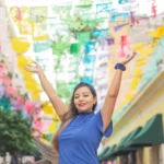 portrait-of-mexican-woman-raising-her-arms