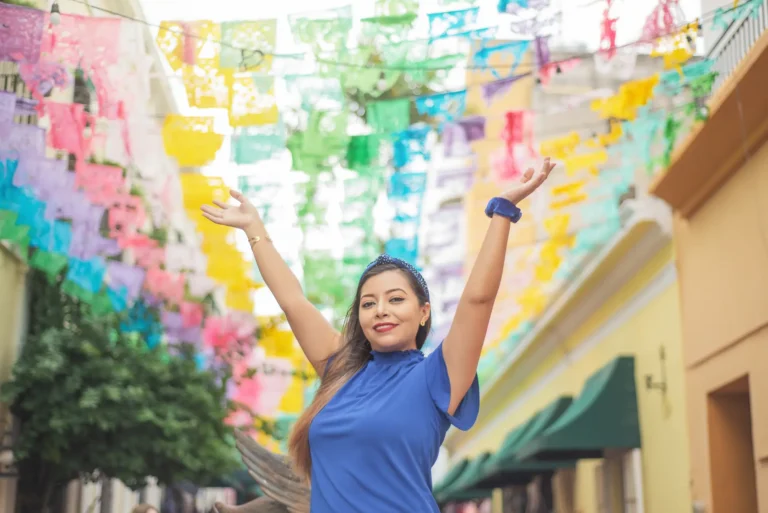 portrait-of-mexican-woman-raising-her-arms