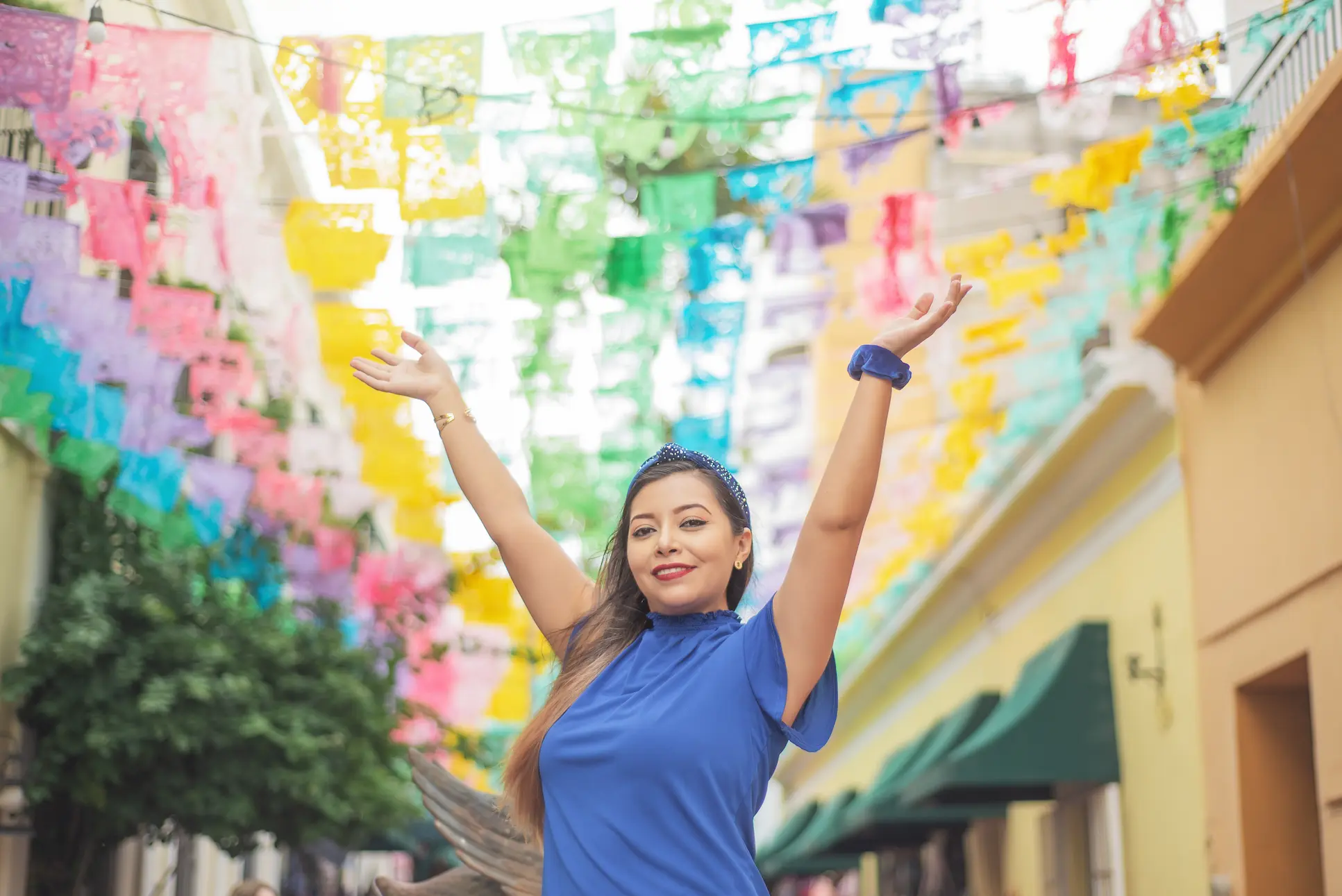 portrait-of-mexican-woman-raising-her-arms