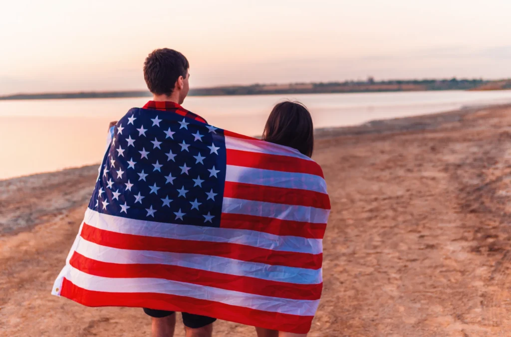 Americans Consider Leaving the U.S. Amid 2024 Election Fears 10 oung couple on the beach walking together 2025 02 12 06 31 21 utc