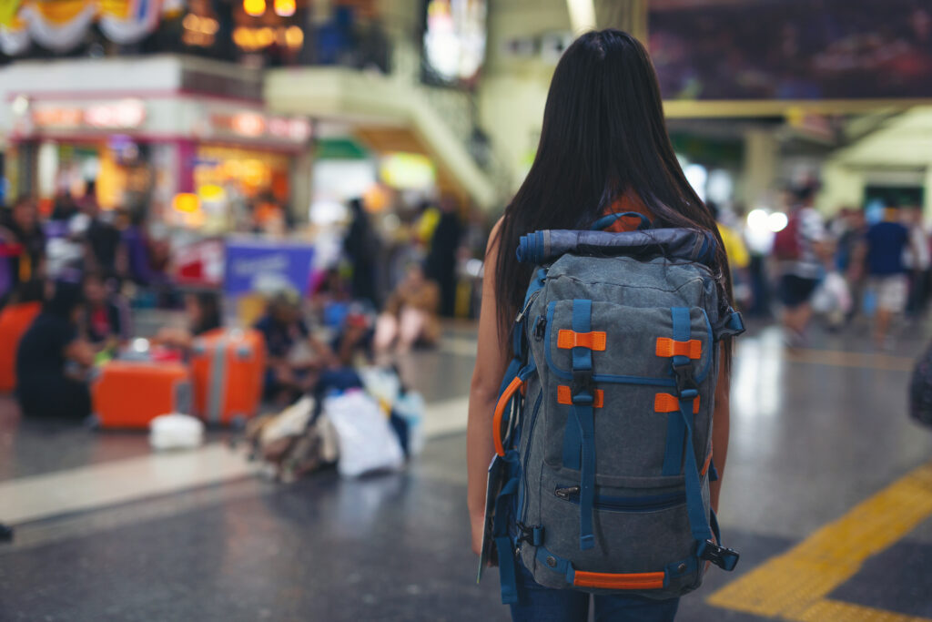 women enjoy traveling map train station