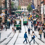 Pedestrians and HSL trams on Aleksanterinkatu in central Helsinki, where Finland permanent residence rules tightened to require 6 years and a language test in 2026