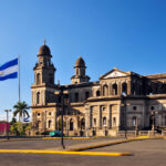 Nicaraguan flag flying over the Old Cathedral of Managua in Plaza de la Revolución, where dual citizenship in Latin America saw its first government-led exit