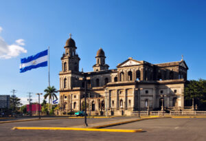 Nicaraguan flag flying over the Old Cathedral of Managua in Plaza de la Revolución, where dual citizenship in Latin America saw its first government-led exit