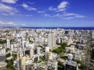 Aerial view of high-rise towers across the Santo Domingo skyline meeting the Caribbean coast, where Americans hold Dominican Republic residence permits