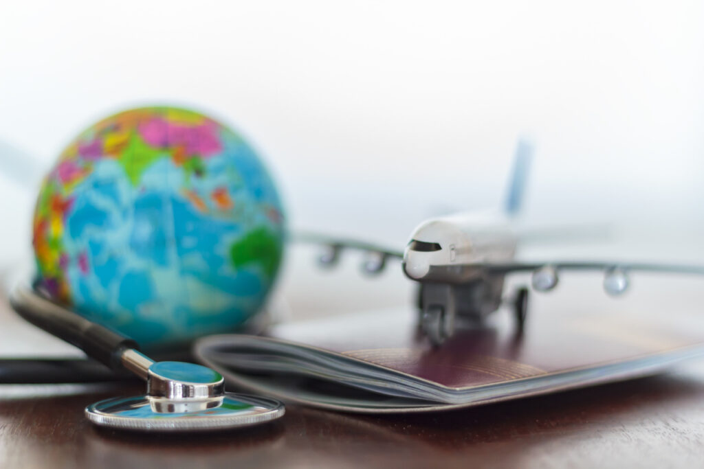 A stethoscope rests on a US passport, illustrating Medicare access questions for Americans abroad