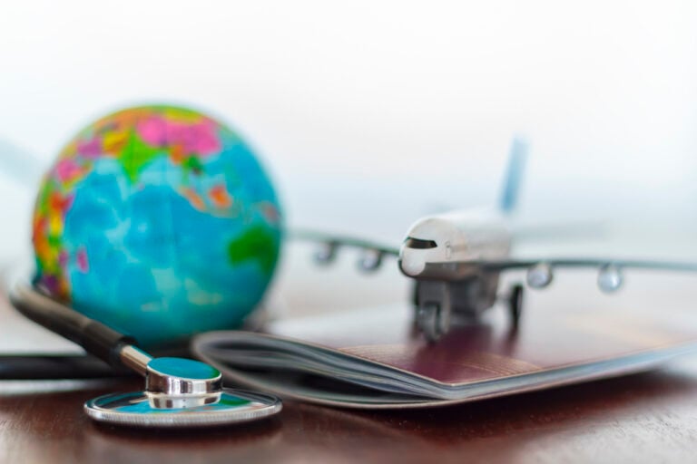 American Emigration Revue 43 A stethoscope rests on a US passport, illustrating Medicare access questions for Americans abroad