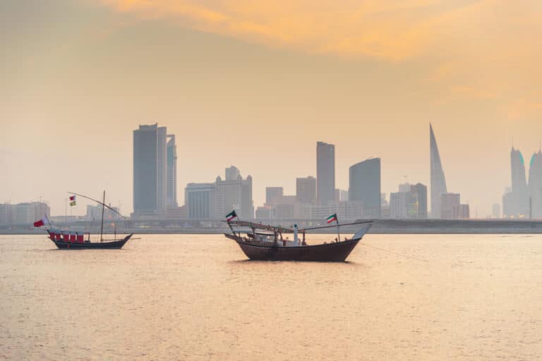 American Emigration Revue 11 Traditional dhows anchored at sunset before the Manama skyline, the Bahraini capital where most Americans in Bahrain live beyond the naval base.