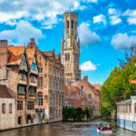 Medieval Belfry tower and brick canal houses in Bruges, where many Belgian citizenship for Americans seekers come.