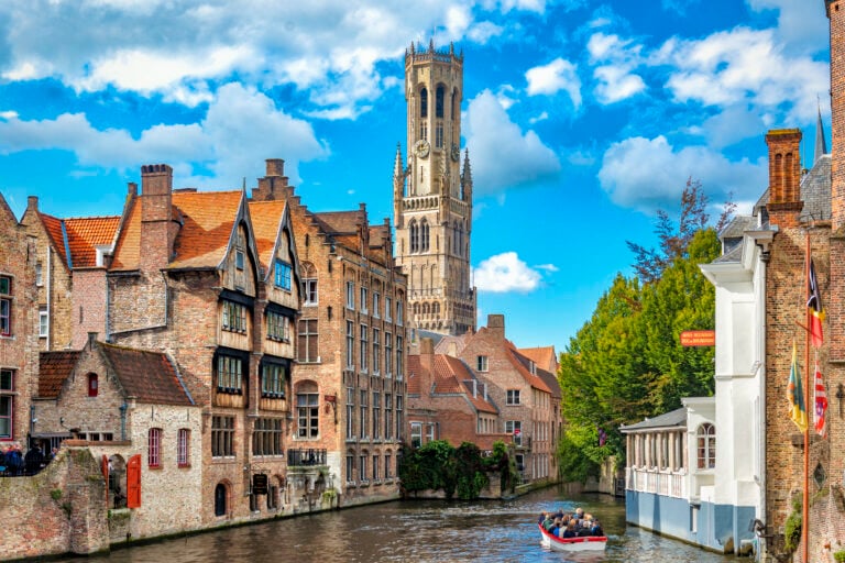 American Emigration Revue 10 Medieval Belfry tower and brick canal houses in Bruges, where many Belgian citizenship for Americans seekers come.