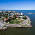 Aerial view of Belize City's coastline and lighthouse on the Caribbean, a hub for Americans in Belize
