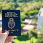 Hand holding a navy Mercosur República Argentina passport outdoors, illustrating the Argentina golden visa citizenship pathway