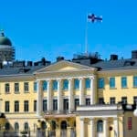 Finnish presidential palace in Helsinki flying the national flag, where the Finland citizenship test takes effect in 2027