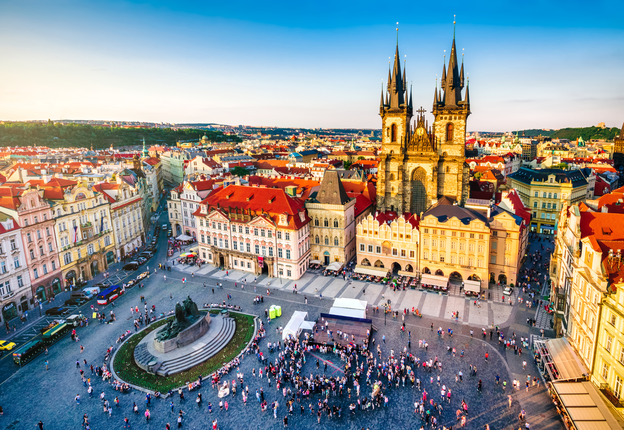 American Emigration Revue 9 Aerial view of Prague's Old Town Square at sunset, with the Gothic spires of Tyn Church and crowds below, in the city where most US citizens in Czechia live.