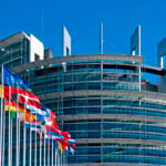 European Union member state flags outside the European Parliament in Strasbourg, where EU residence permits for Americans are recorded in bloc-wide data.