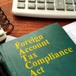FATCA enforcement book, Foreign Account Tax Compliance Act on a table.